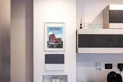 a room with a wall with a picture of a building at Domus Marconi Roma in Rome