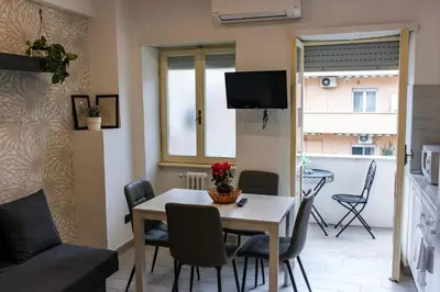 a kitchen and dining room with a table and chairs at Domus Marconi Roma in Rome