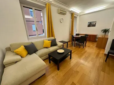 a living room with a couch and a table at San Pietro city center close to the subway in Rome