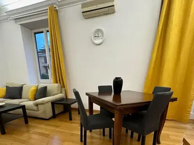 a living room with a table and a couch at San Pietro city center close to the subway in Rome