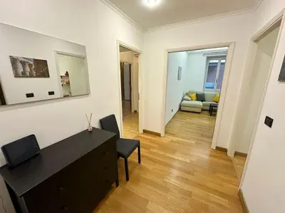 a living room with a black dresser and a couch at San Pietro city center close to the subway in Rome