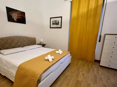 a bedroom with a bed with two towels on it at San Pietro city center close to the subway in Rome