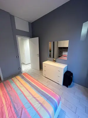 a bedroom with a bed with a dresser and a mirror at Cuore di Testaccio Apartment 2 in Rome