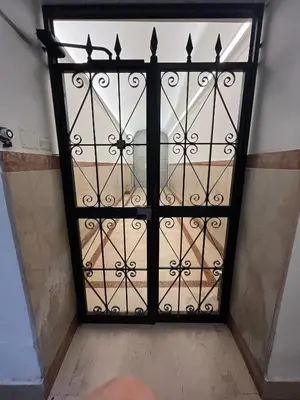 an iron door with a gate in a room at Cuore di Testaccio Apartment 2 in Rome