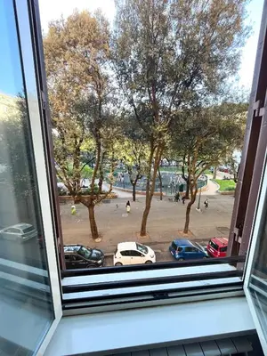 a window with a view of a parking lot at Cuore di Testaccio Apartment 2 in Rome