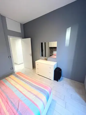 a bedroom with a bed and a dresser and mirror at Cuore di Testaccio Apartment 2 in Rome