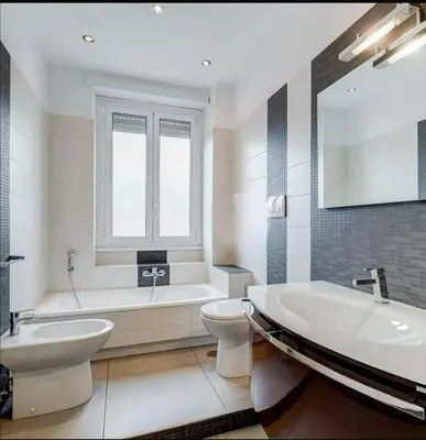 a bathroom with a tub and a toilet and a sink at Domus Testaccio in Rome