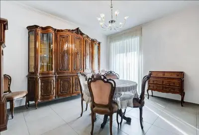 a dining room with a table and a chandelier at Domus Testaccio in Rome