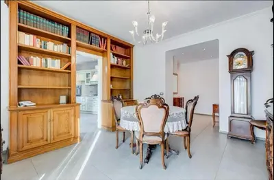 a dining room with a table and chairs and a clock at Domus Testaccio in Rome