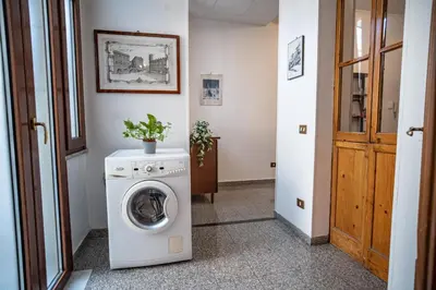 a washer and dryer in a room with a door at Domus Pretorio in Rome