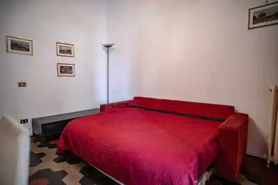 a bedroom with a red bed in a room at Domus Pretorio in Rome