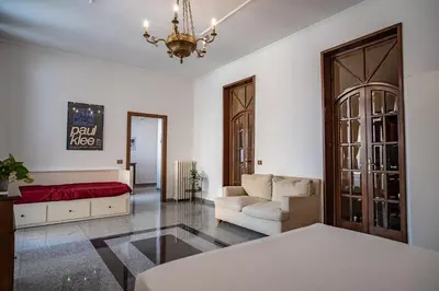 a living room with a couch and a chandelier at Domus Pretorio in Rome