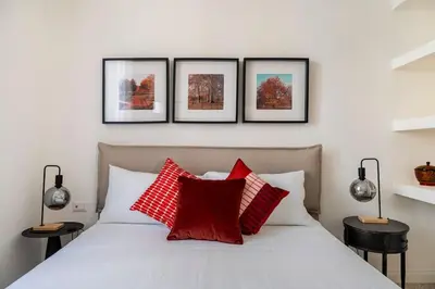 a bedroom with a white bed with red pillows at Your Cozy Home in Rome- Gemelli- close to downtown in Rome