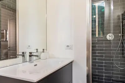 a white bathroom with a sink and a shower at Your Cozy Home in Rome- Gemelli- close to downtown in Rome