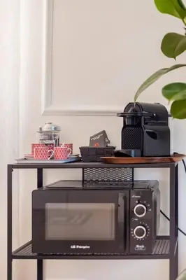 a black shelf with a microwave and a printer at Your Cozy Home in Rome- Gemelli- close to downtown in Rome