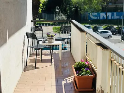 a balcony with chairs and a table with flowers at Pamphili212 in Rome