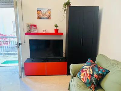 a living room with a flat screen tv and a couch at Pamphili212 in Rome