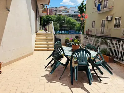 a patio with a table and chairs on a patio at Pamphili212 in Rome