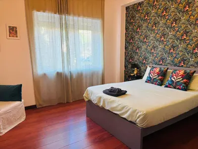 a bedroom with a bed with a large floral wall at Pamphili212 in Rome