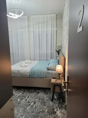 a bedroom with a bed and a table with a lamp at Villa Bonelli Dreams in Rome in Rome