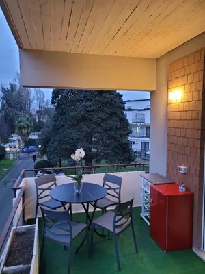 a patio with a table and chairs and a tree at Villa Bonelli Dreams in Rome in Rome