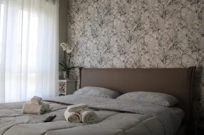 a bedroom with a bed with a floral wallpaper at Villa Bonelli Dreams in Rome in Rome