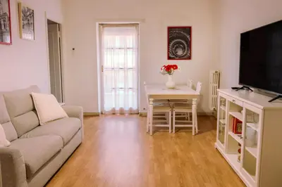 a living room with a couch and a table with a tv at 1512 Apartment in Rome