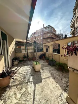 a courtyard of a building with potted plants at 1512 Apartment in Rome