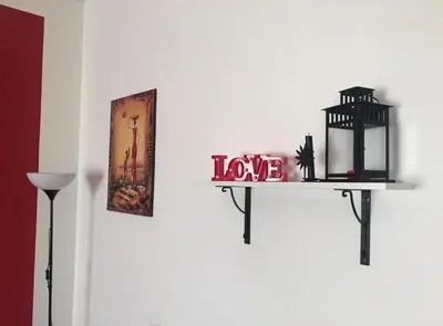 a shelf with a love sign on a wall at CORNELIUS in Rome