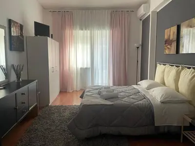 a bedroom with a bed and a dresser and a window at CORNELIUS in Rome