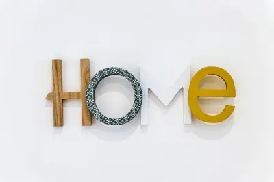 a sign for the word home with wooden letters and a hop at Appartamento via Milizia in Rome