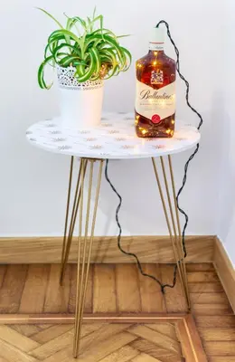 a table with a bottle of whiskey and a plant at Appartamento via Milizia in Rome