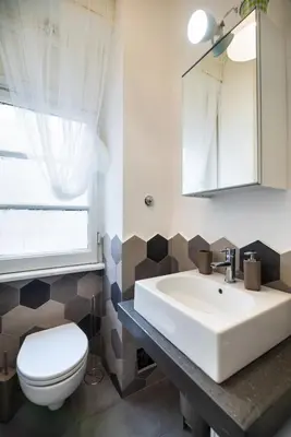 a bathroom with a white sink and a toilet at Appartamento via Milizia in Rome