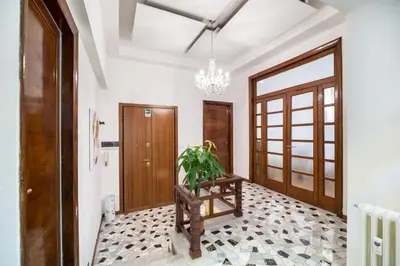 a hallway with a door and a potted plant at Appartamento via Milizia in Rome