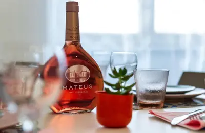 a bottle of wine sitting on a table with glasses at Appartamento via Milizia in Rome