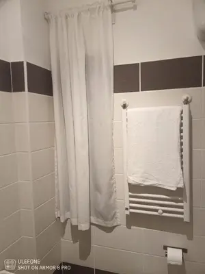 a bathroom with a white shower curtain and a towel at Jack's House - Tourist Rentals - in Rome