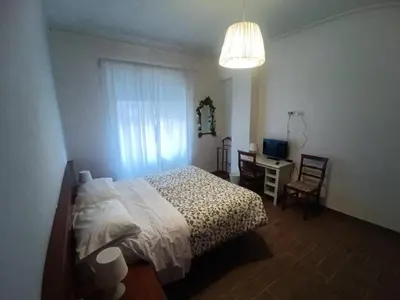 a bedroom with a bed and a desk and a window at Jack's House - Tourist Rentals - in Rome