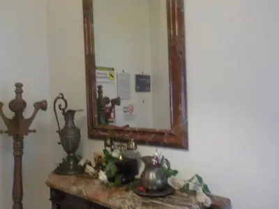 a mirror on a wall next to a table with tea pots at Jack's House - Tourist Rentals - in Rome