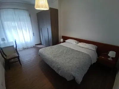 a bedroom with a bed and a chair and a window at Jack's House - Tourist Rentals - in Rome