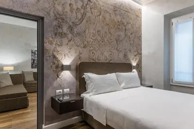 a bedroom with a bed and a couch at MyItalyHome Roma in Rome