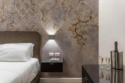 a bedroom with a bed and a table with wine glasses at MyItalyHome Roma in Rome