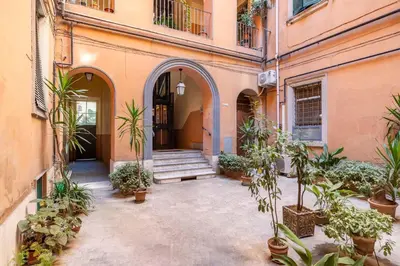 an empty courtyard with potted plants in a building at Grande e storico appartamento ai Musei Vaticani in Rome