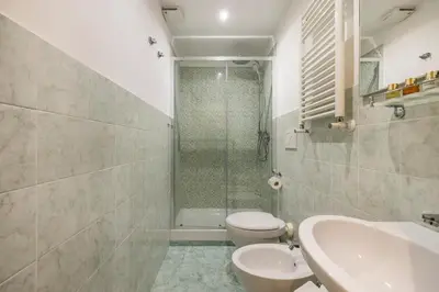 a bathroom with a shower and a toilet and a sink at Grande e storico appartamento ai Musei Vaticani in Rome