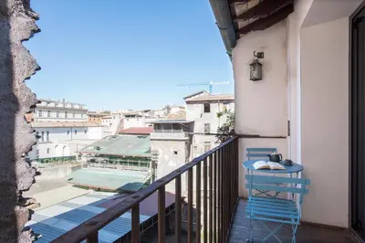a balcony with a table and a view of a city at Imperial Forums Apartment IN Campitelli in Rome