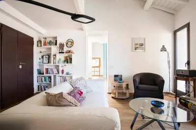 a living room with a white couch and a glass table at Imperial Forums Apartment IN Campitelli in Rome