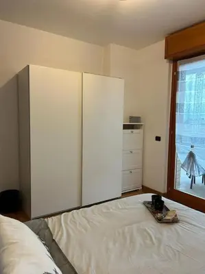 a bedroom with a bed with a dresser and a window at Miro Home in Rome