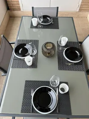 a table with black plates and wine glasses on it at Miro Home in Rome