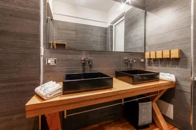 a bathroom with two sinks and a mirror at Domus Rea - Vaticano - Metro Baldo degli Ubaldi in Rome