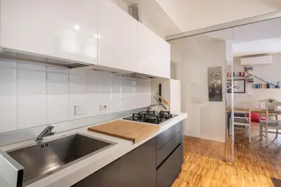 a white kitchen with a sink and a stove at Domus Rea - Vaticano - Metro Baldo degli Ubaldi in Rome
