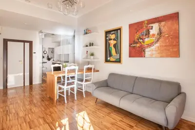 a living room with a couch and a table at Domus Rea - Vaticano - Metro Baldo degli Ubaldi in Rome
